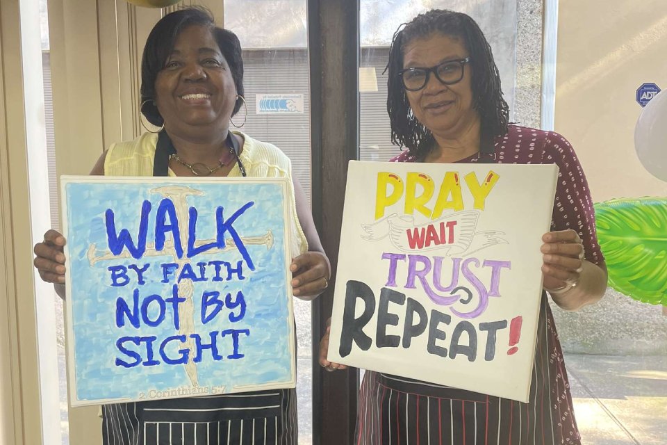 Two woman with painted signs